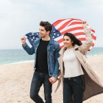 a man and a woman holding an american flag