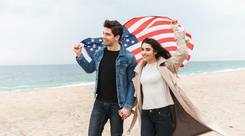a man and a woman holding an american flag